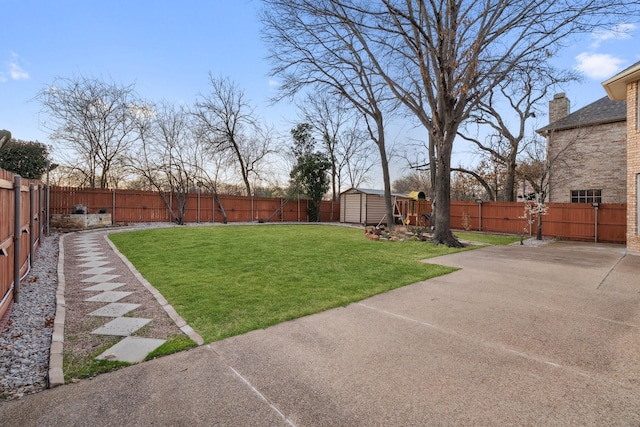 view of yard featuring a patio area, a storage unit, an outbuilding, and a fenced backyard