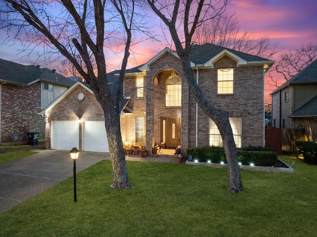 traditional-style home featuring brick siding, a front lawn, concrete driveway, roof with shingles, and an attached garage