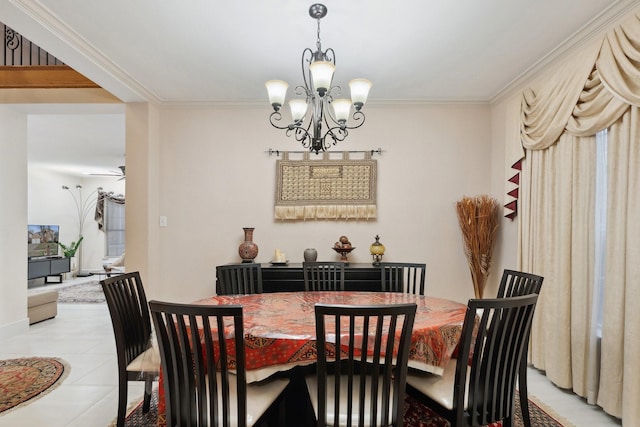 dining space with ornamental molding, light tile patterned flooring, and ceiling fan with notable chandelier