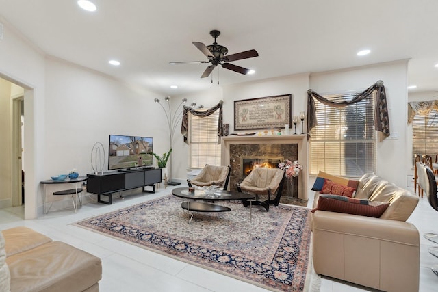 tiled living area featuring recessed lighting, a fireplace, and a ceiling fan