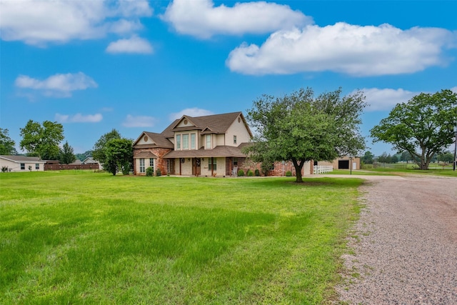 view of front facade featuring a front lawn and brick siding