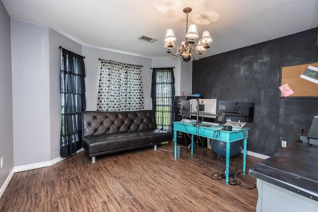 office with an accent wall, wood finished floors, visible vents, and baseboards