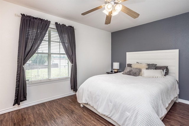 bedroom featuring wood finished floors, baseboards, and ceiling fan