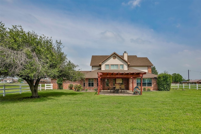 back of property featuring a pergola, a patio, a yard, brick siding, and a chimney