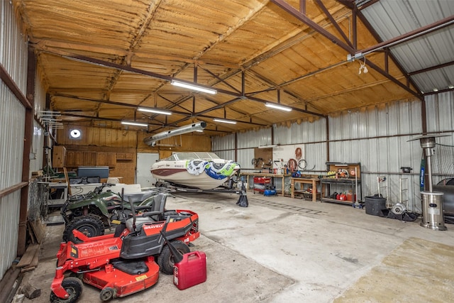 garage with a workshop area and metal wall