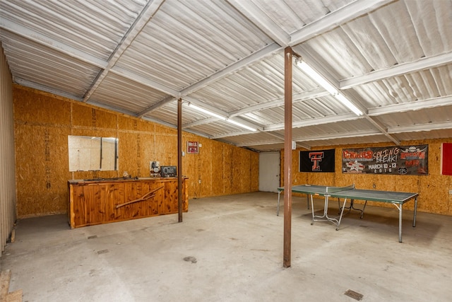 miscellaneous room featuring metal wall and concrete flooring