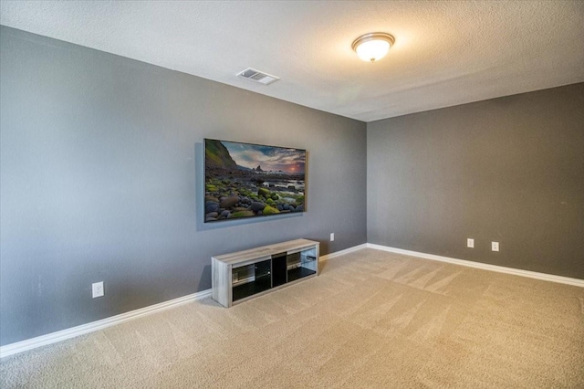 spare room with carpet flooring, baseboards, and visible vents