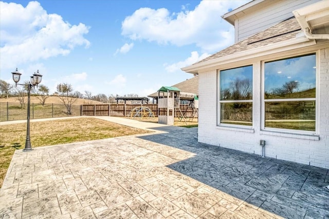 view of yard with a patio, a playground, and fence