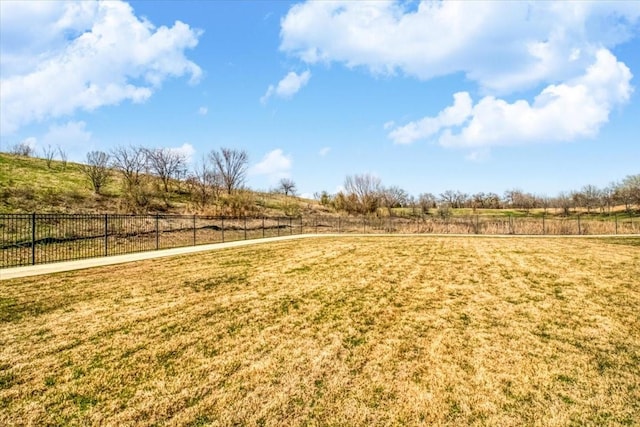 view of yard with a rural view and fence