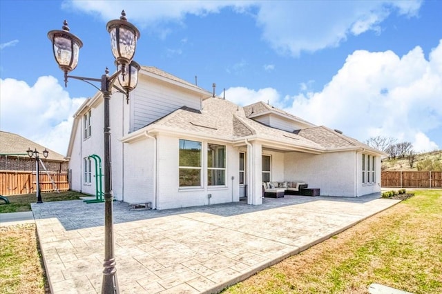 back of house featuring a patio, fence, an outdoor living space, and roof with shingles