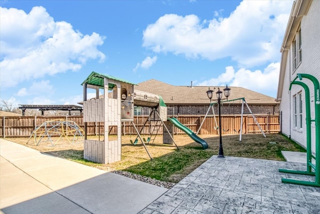 view of play area featuring a fenced backyard and a patio area