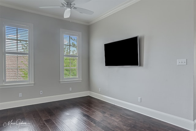 spare room featuring baseboards, ornamental molding, a ceiling fan, and dark wood finished floors
