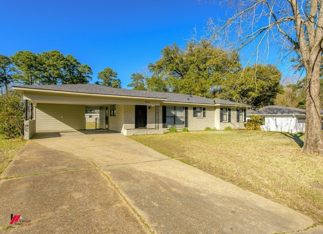 ranch-style house featuring brick siding, a carport, concrete driveway, and a front lawn