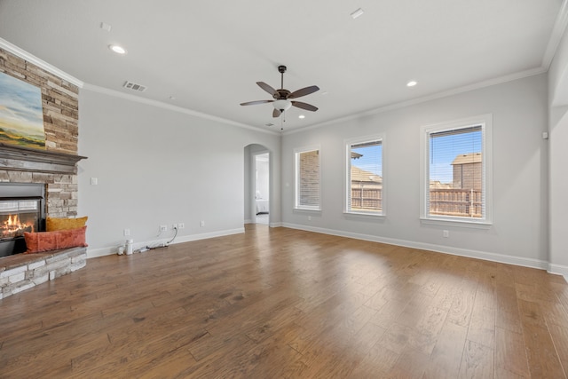 1109 Rendon Pl, Mansfield, TX 76063 - unfurnished living room featuring ceiling fan, a stone fireplace, arched walkways, wood finished floors, and recessed lighting