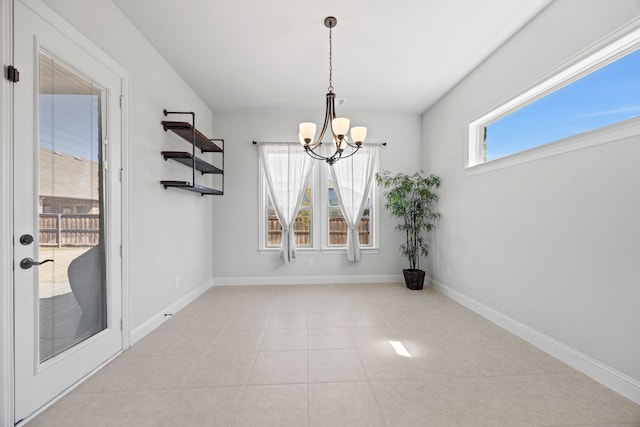 unfurnished dining area with light tile patterned floors, baseboards, and an inviting chandelier