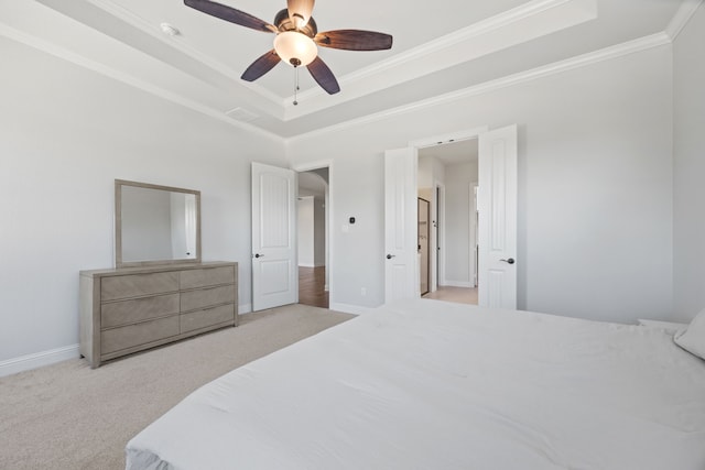 bedroom featuring crown molding, baseboards, carpet flooring, a raised ceiling, and a ceiling fan