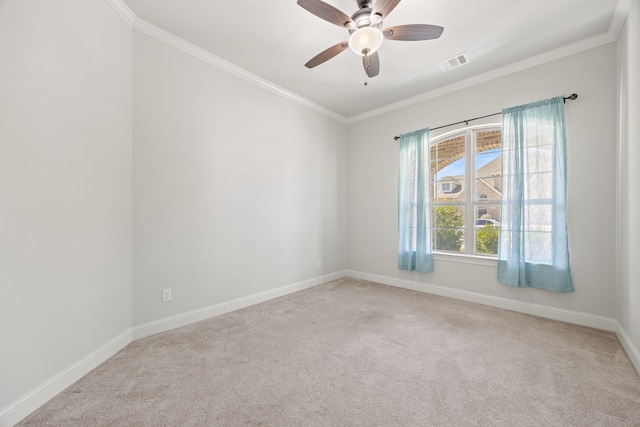 spare room featuring visible vents, a ceiling fan, carpet floors, crown molding, and baseboards