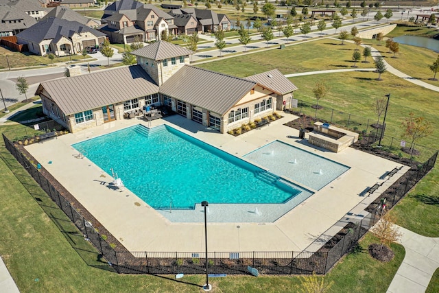 community pool featuring a patio and a fenced backyard