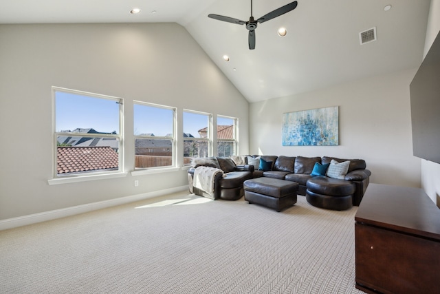 living area with visible vents, carpet floors, high vaulted ceiling, and baseboards