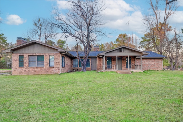 single story home with a front yard, covered porch, brick siding, and a chimney