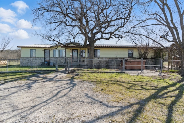 view of front of house with a gate, a fenced front yard, and metal roof