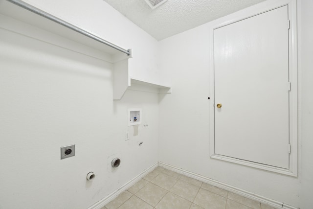 laundry area with washer hookup, laundry area, hookup for a gas dryer, hookup for an electric dryer, and a textured ceiling