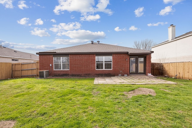 back of property featuring a patio area, brick siding, a fenced backyard, and a lawn