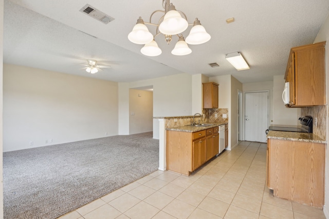 kitchen with visible vents, backsplash, light colored carpet, white appliances, and a sink