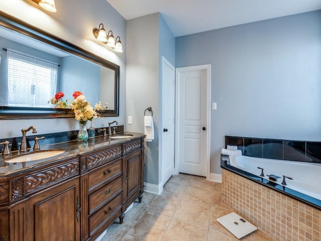 bathroom with tile patterned flooring, double vanity, tiled bath, and a sink