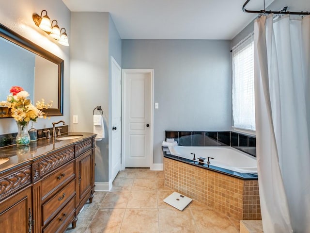 full bath featuring baseboards, tiled tub, vanity, and tile patterned flooring