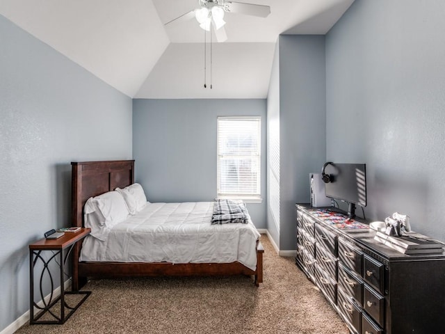 carpeted bedroom featuring vaulted ceiling, baseboards, and ceiling fan