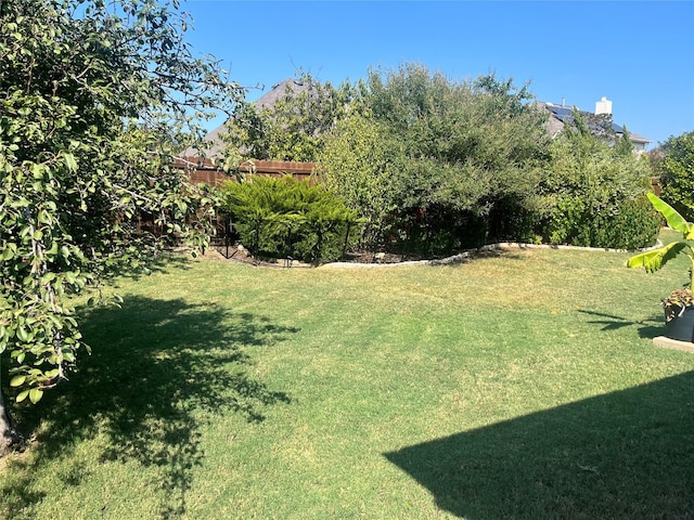 2453 Dawn Mist Dr, Little Elm, TX 75068 - rear view of property featuring a chimney, a fenced backyard, brick siding, roof with shingles, and a patio area