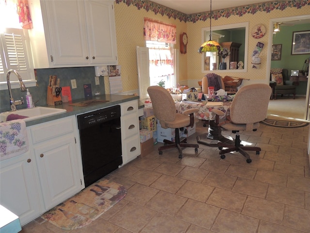 kitchen featuring a sink, decorative light fixtures, black dishwasher, white cabinetry, and wallpapered walls