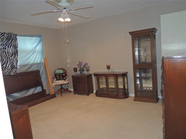 living area featuring baseboards, ceiling fan, and carpet floors