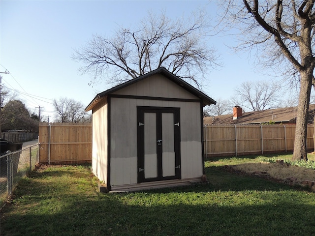 view of shed with a fenced backyard