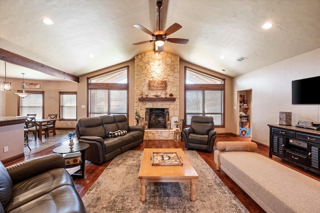 living room with visible vents, a fireplace, dark wood-style floors, and vaulted ceiling with beams