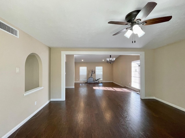 interior space with plenty of natural light, wood finished floors, visible vents, and baseboards