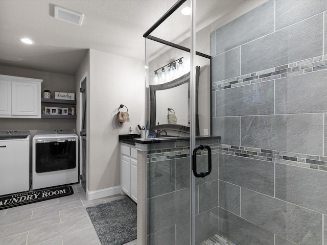 full bathroom with visible vents, recessed lighting, a stall shower, washer and dryer, and vanity