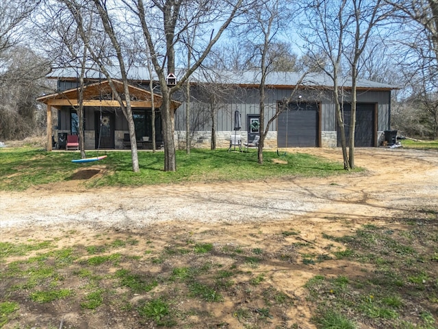 view of outbuilding with an outdoor structure and dirt driveway