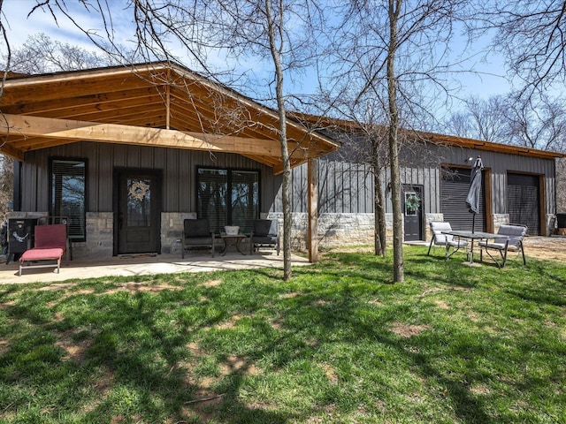 rear view of property with a yard and a patio area