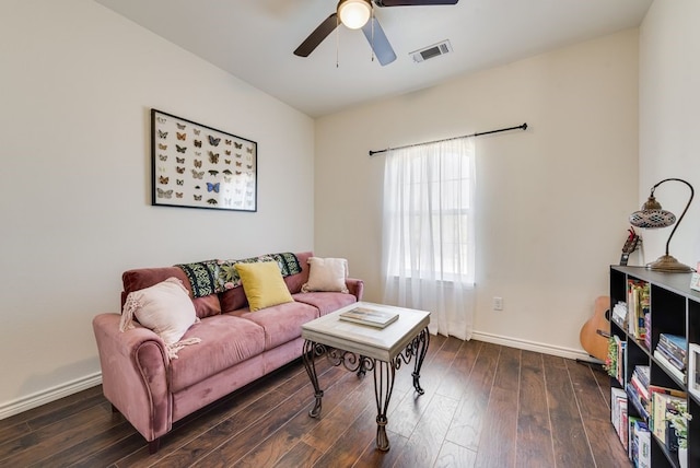 living area featuring visible vents, wood-type flooring, baseboards, and ceiling fan