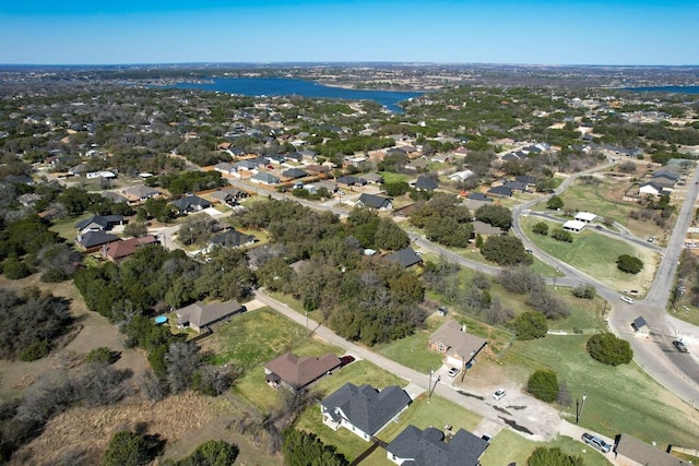 drone / aerial view featuring a residential view and a water view