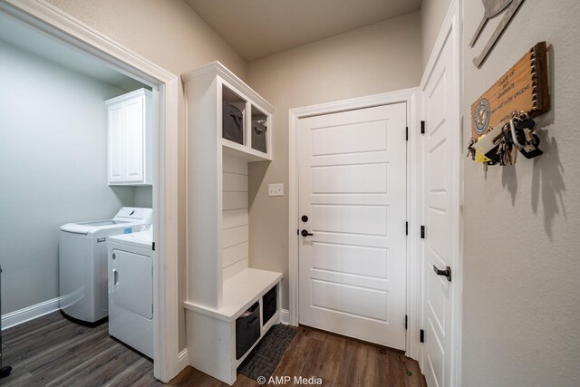 laundry area featuring baseboards, cabinet space, independent washer and dryer, and dark wood finished floors