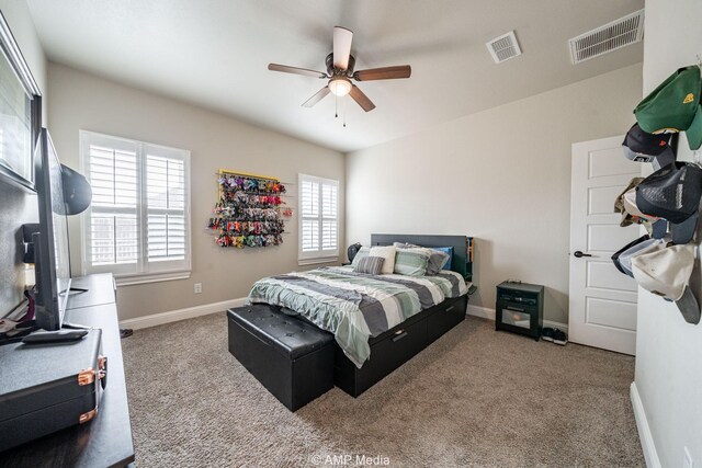 carpeted bedroom featuring visible vents, baseboards, and ceiling fan