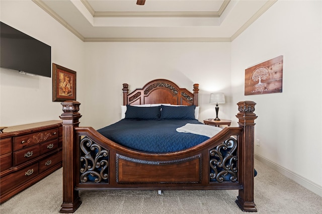 bedroom with baseboards, a raised ceiling, carpet, and crown molding