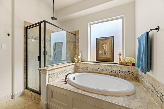 full bath featuring tile patterned floors, a garden tub, and a shower stall