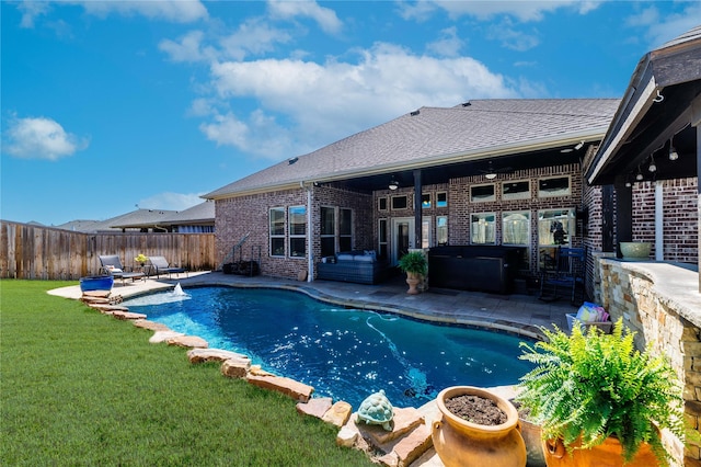 view of pool with a yard, a patio, a fenced in pool, and a fenced backyard