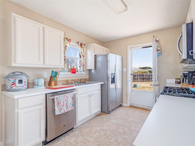 kitchen with a sink, light countertops, white cabinets, and stainless steel appliances