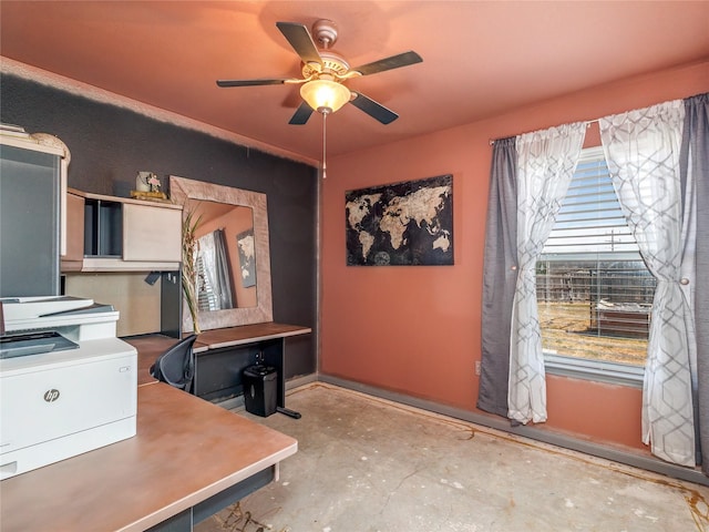 office with unfinished concrete flooring and ceiling fan