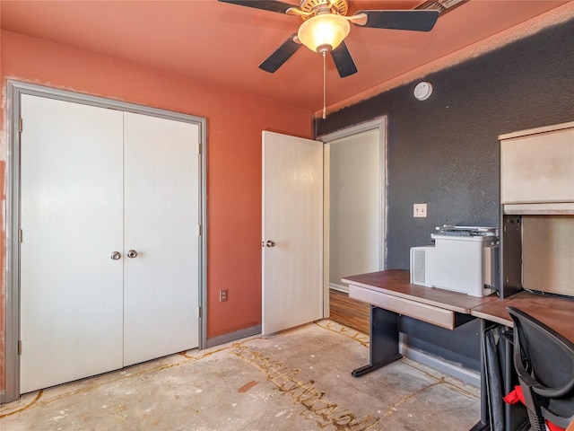 home office featuring concrete floors and ceiling fan